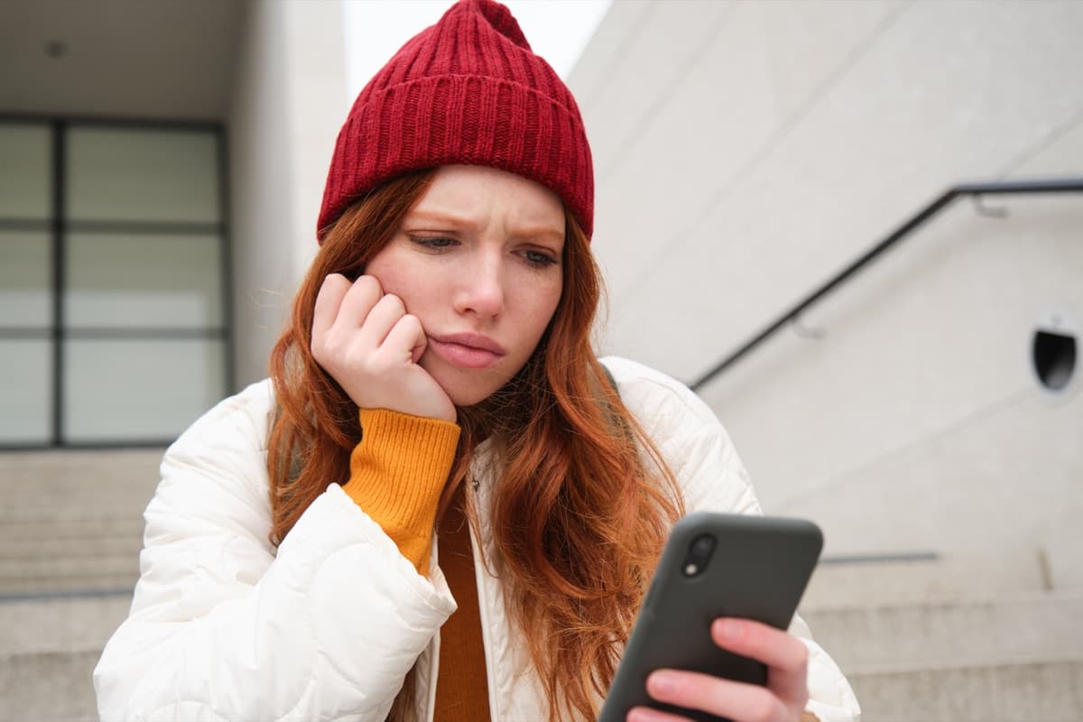 Person frustrated while looking at phone