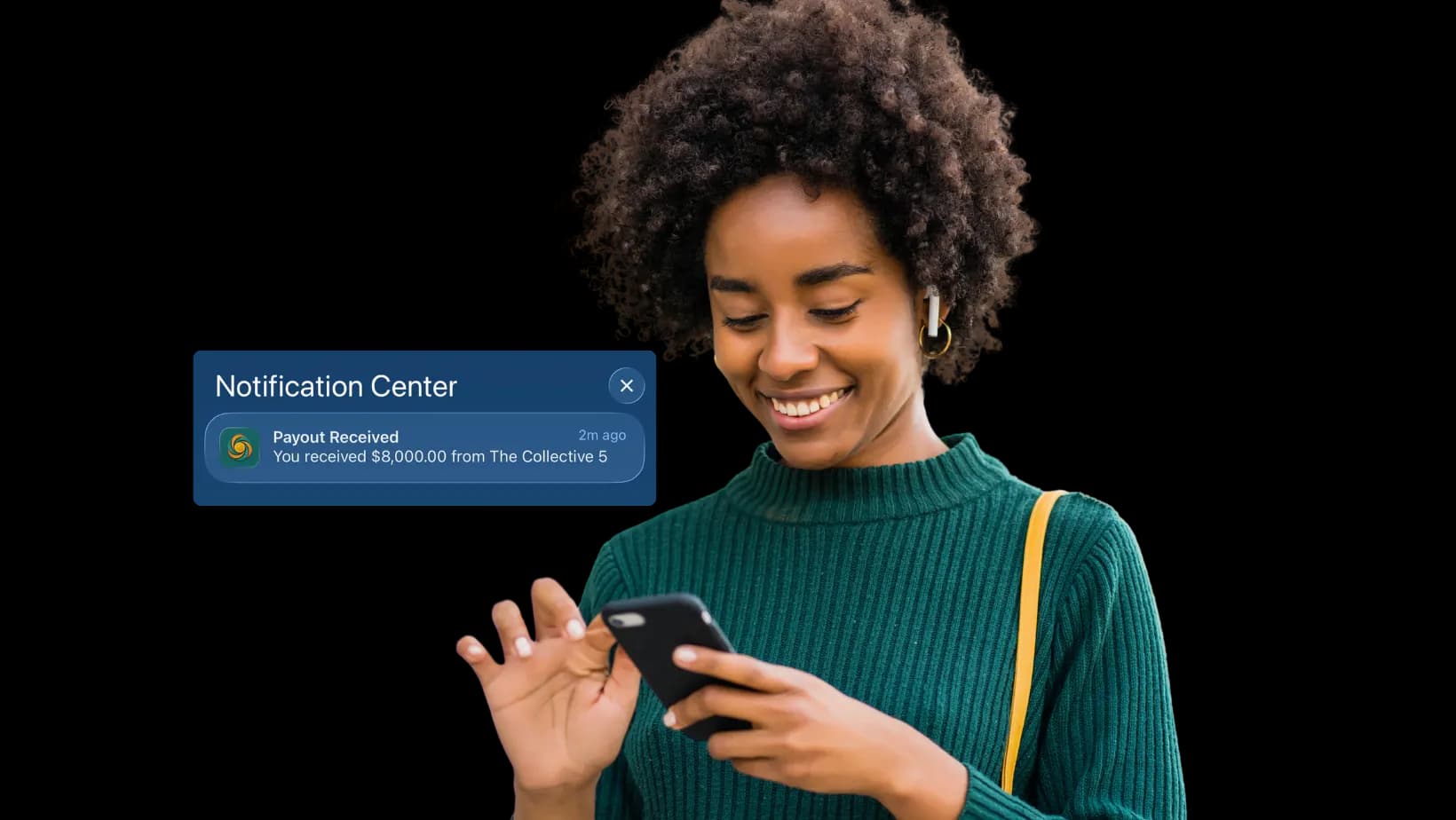 Woman smiling at her phone after receiving an $8,000 payout from Susu